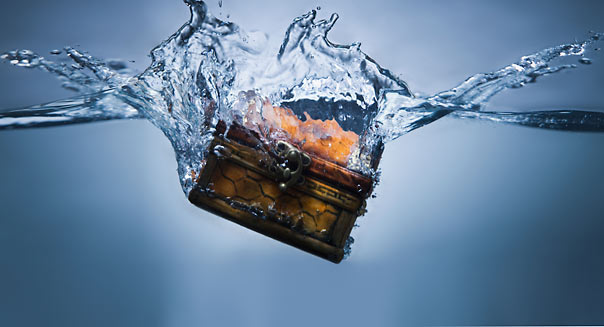 Treasure chest sinking in water. Image shot 2010. Exact date unknown.